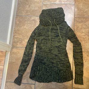 The color is avocado green black sweater with a turtleneck